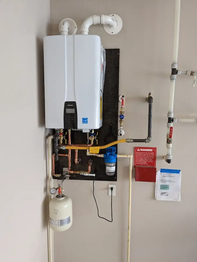 Professional plumber installing copper piping in a Los Lunas home